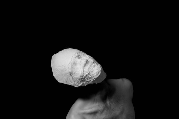 black and white photo of a man in a plaster mask