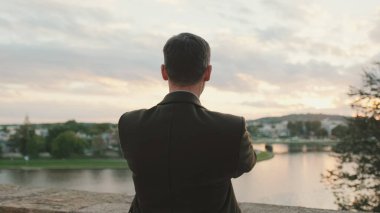 Adam resimli nehir kıyısının videosunu çekiyor. Arka plan