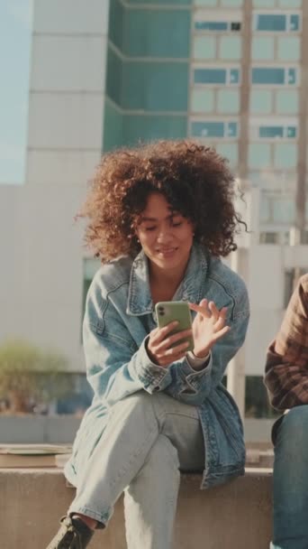Smiling Girl Student Sits Next Building University Uses Mobile Phone — Vídeos de Stock