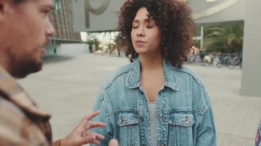 Close up, young man emotionally tells his girlfriend