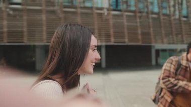 Student filming a stream with her friends on a mobile phone