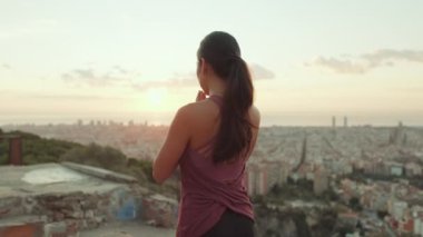 Girl meditates sitting on the observation deck at dawn