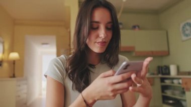 Close-up of girl scrolling through photos and videos on her smartphone