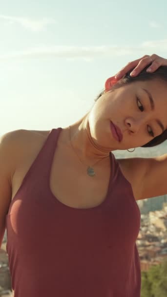 Vertical Video Young Woman Stretches Her Neck Muscles While Standing — Stok video
