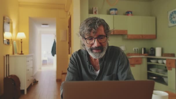 Senier Works Laptop Raises His Eyes Smiles Camera — Vídeo de stock