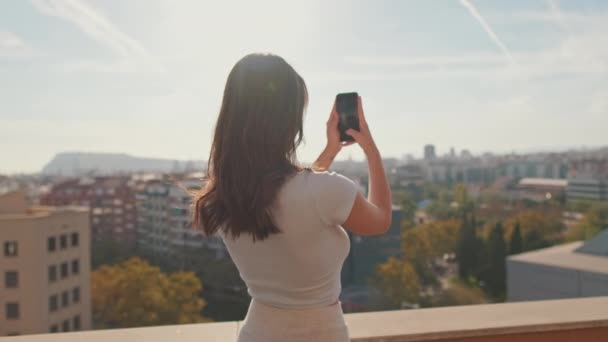 Young Woman Takes Photo Mobile Phone While Standing Balcony Home — Video