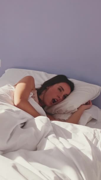 Vertical Video Young Woman Wakes Stretches Her Bed — Vídeos de Stock