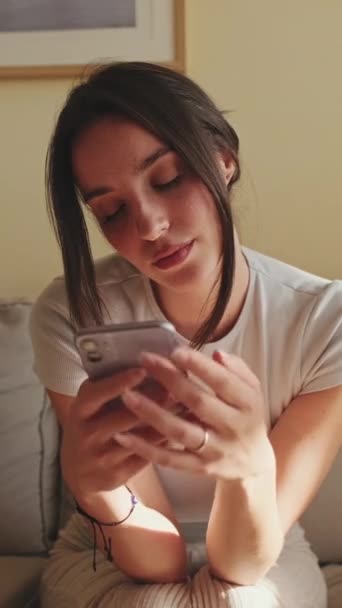 Vertical Video Young Woman Using Mobile Phone Texting Scrolling While — Vídeo de stock