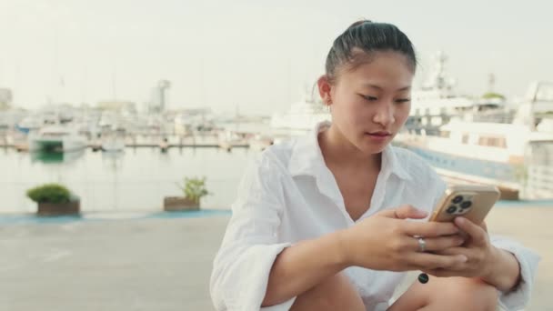 Young Woman Uses Mobile Phone Seascape Background — Stok video