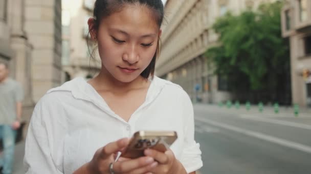 Jonge Vrouw Die Een Mobiele Telefoon Gebruikt Terwijl Naast Weg — Stockvideo