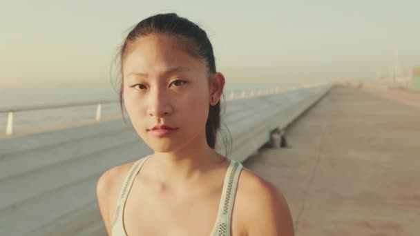 Close Asian Girl Sports Top Walks Promenade Looks Camera — Video