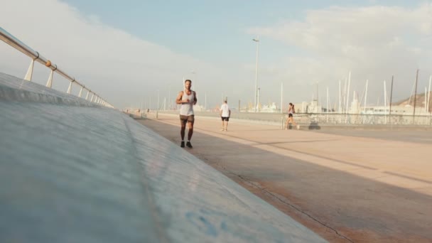 Young Bearded Male Fit Athlete Runs Promenade — Stockvideo