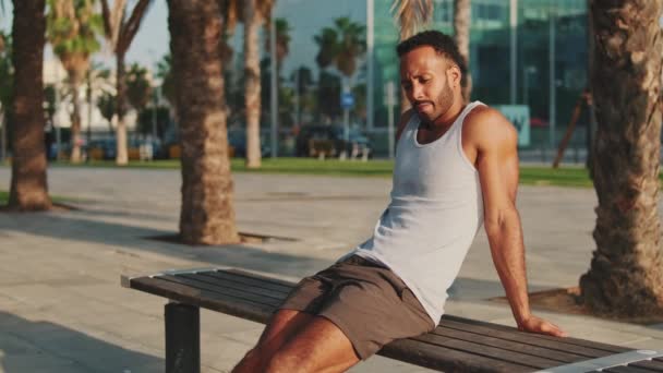 Young Bearded Male Athlete Resting Training Sitting Bench — Stockvideo