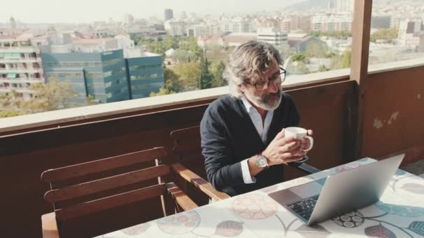 Mature Man Working Laptop Drinking Mug While Sitting Balcony — Video Stock
