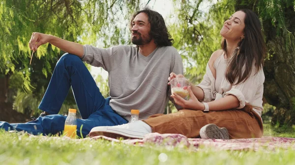 公園のピクニックで携帯電話を使用して愛のカップル — ストック写真