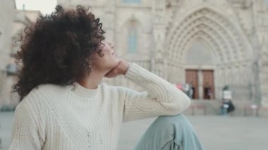 Eski kasaba meydanının güzel manzarasının tadını çıkaran bir kadın turistin yakın çekimi.