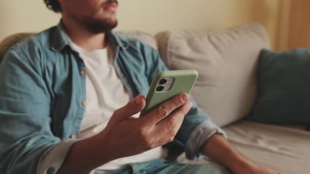 Close Hands Unrecognizable Man Sitting Sofa Using Mobile Phone — Stock Video