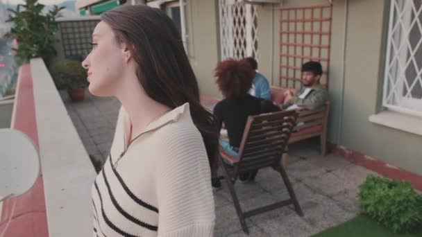 Mujer Joven Mira Ciudad Mientras Está Pie Balcón Sus Amigos — Vídeos de Stock