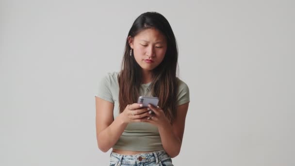 Mujer Joven Mensajes Texto Teléfono Aislado Sobre Fondo Blanco Estudio — Vídeos de Stock