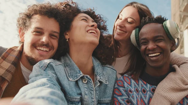 Szczęśliwi Uśmiechnięci Przyjaciele Wykonują Wideo Rozmowę Telefonu Komórkowego Czterech Uczniów — Zdjęcie stockowe