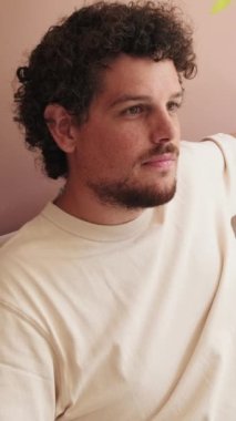 Oturma odasındaki kanepede dinlenen adam.