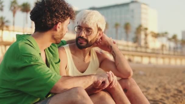 Homosexual Couple Cross Arms Hug While Sitting Beach — Stock Video