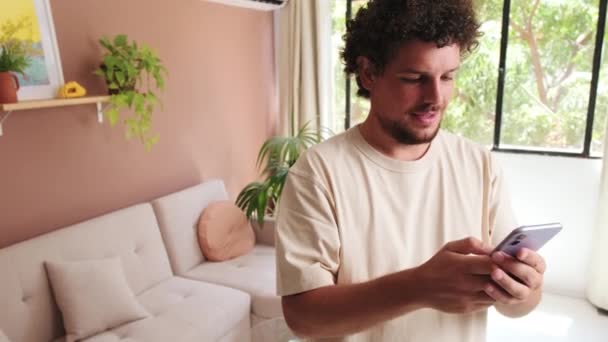 Guy Using Mobile Phone While Standing Cozy Living Room — Stock Video
