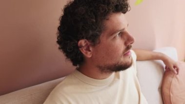 Yaklaş, rahat bir oturma odasında koltukta dinlenen adam.