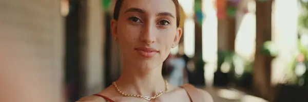 stock image Close-up young woman takes a selfie, video call on the street on urban background. Smiling girl use social media, streaming service