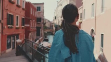 Venedik 'te yürüyen genç bir bayan turist.