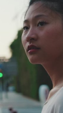 Yakından, genç kadın yaya geçidinde dikilirken etrafına bakıyor.