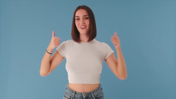 Smiling Woman Showing Double Thumbs Gesture Looking Camera Isolated Blue — Stock Video