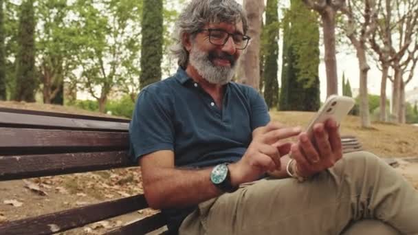 Parkta Otururken Gülümseyen Yaşlı Adamın Yakın Plan Fotoğrafı — Stok video