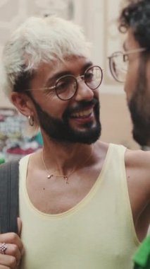 Dikey video, gay çift eski şehrin caddesinde duruyor, kamera ilerliyor.