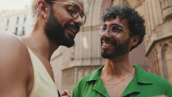 Stock image Close-up, laughing homosexual couple using mobile phone while standing on street of old city