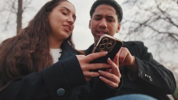 Young Couple Looking Smartphone Together Outdoors — Stock Video