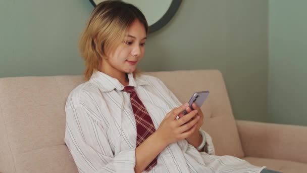 Woman Using Smartphone Device Sitting Living Room Sofa — Stock Video