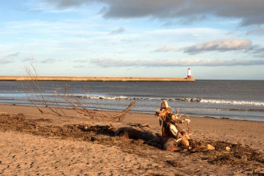 wood debris, sea and beach and pier at Spittal, Berwick-upon-Tweed, Northumberland