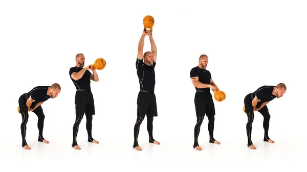 A kettlebell trainer demonstrating the American kettlebell swing with a yellow kettlebell isolated on a white background