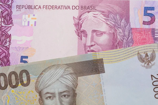 ブラジルのピンクと紫の5つの本物の銀行券のマクロ画像は 灰色の2000インドネシアルピア銀行券と対になりました マクロでショットを閉じる — ストック写真