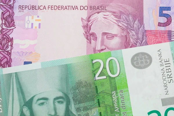 巴西面额为粉色和紫色的5张真实钞票与塞尔维亚面额为20第纳尔的绿色和白色钞票搭配在一起的宏观图像 在宏观上拍的特写 — 图库照片