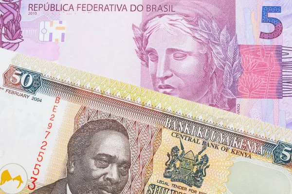 巴西面额为粉色和紫色的5张真实钞票与肯尼亚面额为50先令的五颜六色钞票搭配在一起的宏观图像 在宏观上拍的特写 — 图库照片