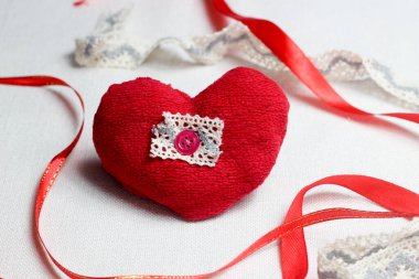 Hand made red heart close up on light background with red ribbon, Valentine day postcard,holiday wallpaper,cover design,needlework hobby.