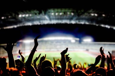 football or soccer fans at a game in a stadium world cup clipart