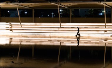 İnsanlar floresan şehir ışıklarında siluetler