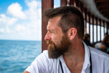 handsome caucasian man travelling on a local ferry