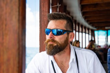 handsome caucasian man travelling on a local ferry