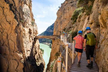 elderly couple trekking in Caminito Del Rey Trail in Andalusia clipart