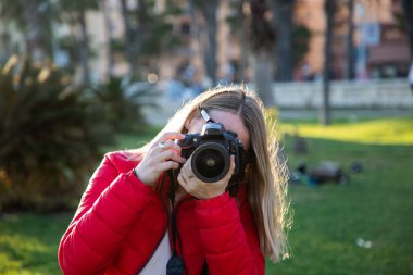 Mutlu güzel kadın parkta günbatımının tadını çıkarıyor.