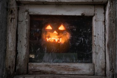 Geceleri pencerede parlayan korkunç Cadılar Bayramı kabağı